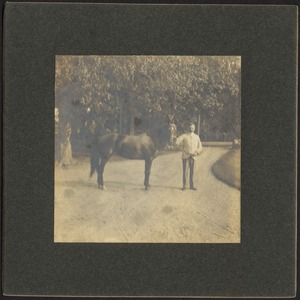 Ashdale Farm. Man standing with horse in driveway, possibly Otto Kunhardt.