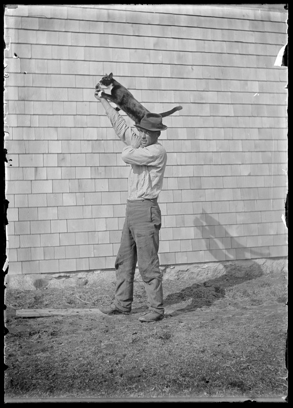 Man with cat on arm