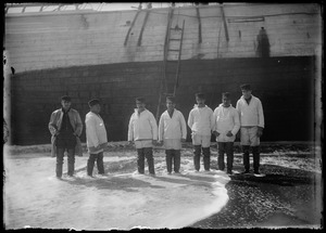 Group of men wearing boots, ladder on boat