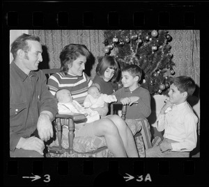 Home with her twin sister in time for the holidays, little Maria Abkarian (on right in her mom's arms) enjoys admiring glances from other members of the Monouk Abkarian family at their home on Houghton St. in Lynn