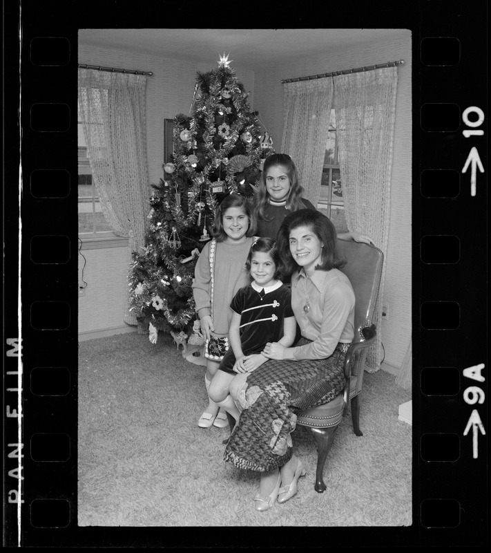 Unidentified woman and children posing with Christmas tree Digital