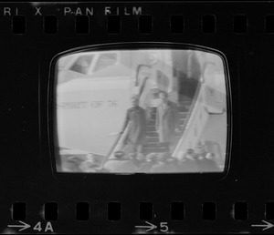 Television showing President Richard Nixon and Pat Nixon arriving in Beijing