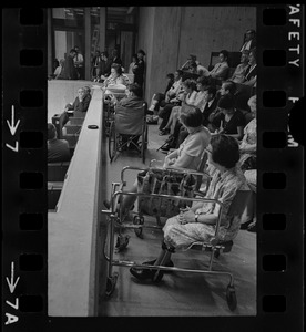 Helene Cummings addresses City Council hearing on the plight of handicapped persons from her stretcher-bed