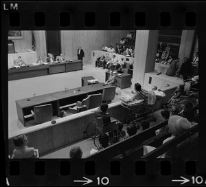 Helene Cummings addresses City Council hearing on the plight of handicapped persons from her stretcher-bed