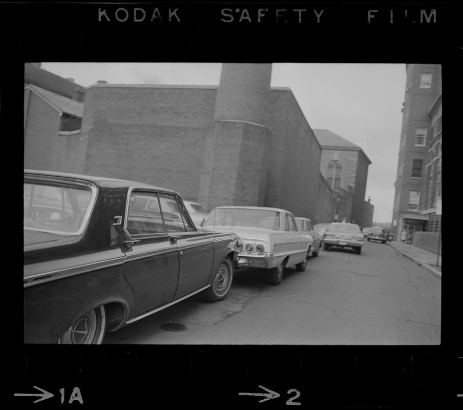 Line of cars parked on street, following an escape from Charles Street Jail