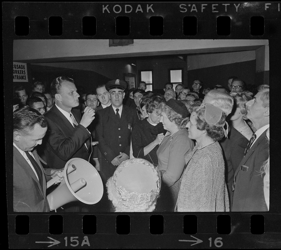 Billy Graham greeting and speaking to people unable to get into the Boston Garden to see him