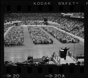 Billy Graham speaking at Boston Garden, crowd in front of him in three sections