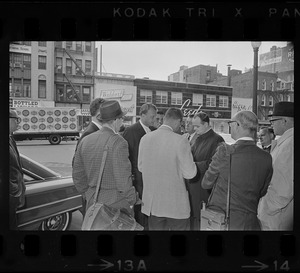 Billy Graham outside of Hotel Statler Hilton in Boston speaking with reporters