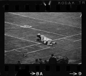 Football player being tackled onto ground