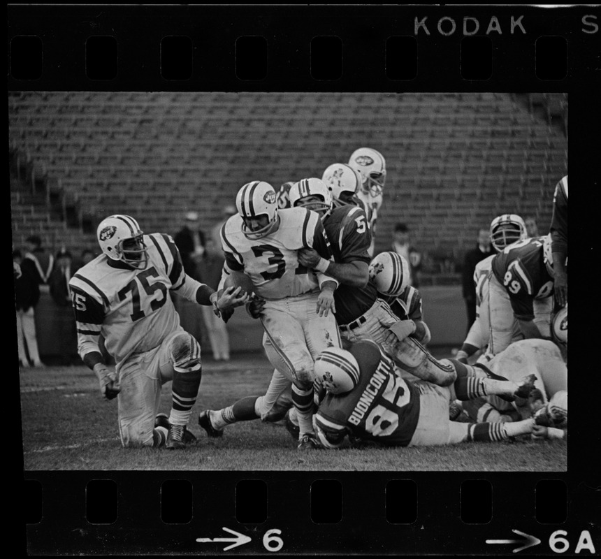 New England Patriots player tackling New York Jets player in a football game