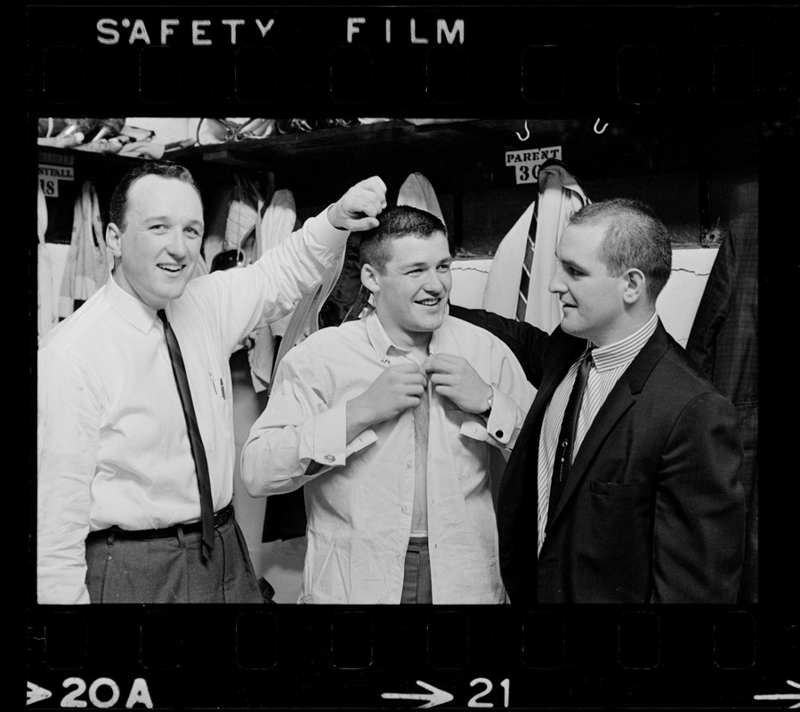 Three Boston Bruins hockey players including Bernie Parent, middle