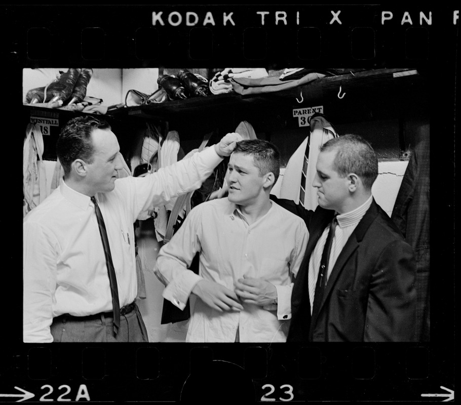 Three Boston Bruins hockey players including Bernie Parent, middle