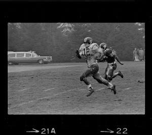 Football player with possession of the ball and running