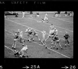 Football player jumping to catch ball during a game