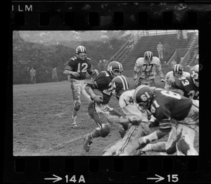 Football player with ball while other players are in foreground