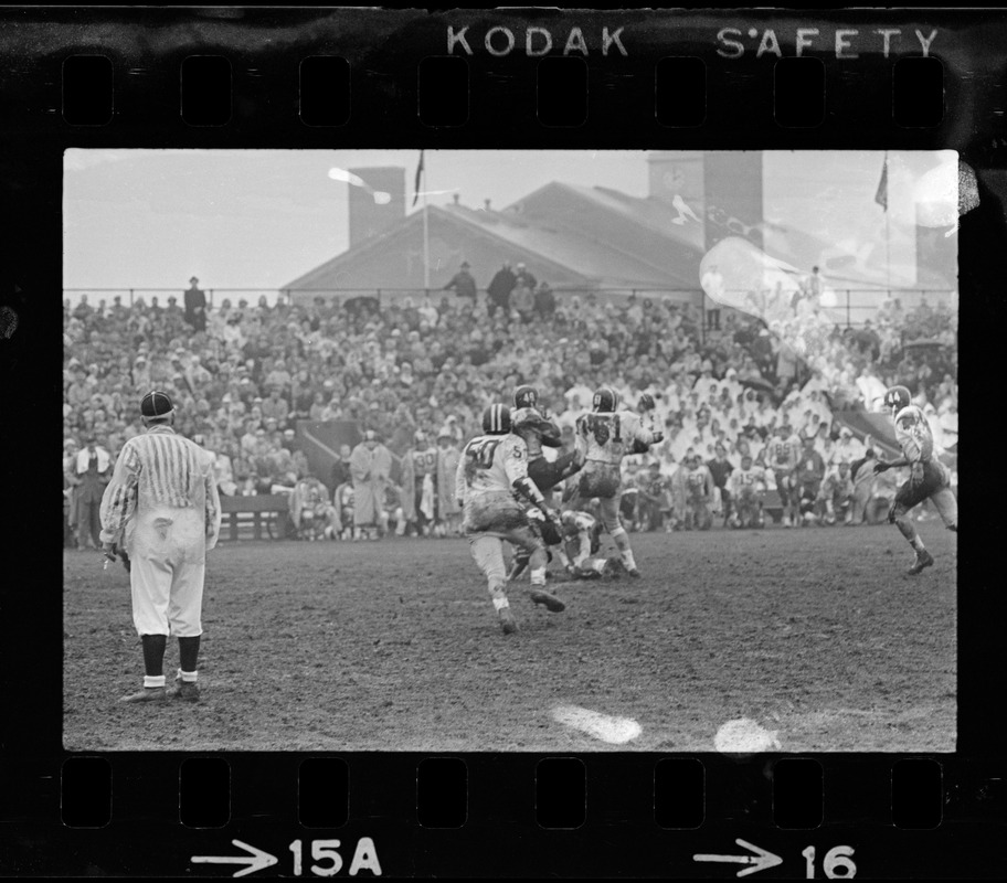 Football game and spectators in bleachers