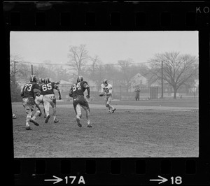Football player with ball seen while opponents approach