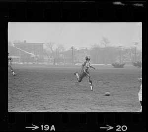 Football player running toward ball on the ground