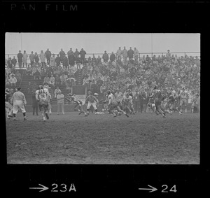 People in bleachers watching a football game