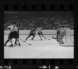 Boston Bruins player shooting on Toronto Maple Leafs' goal