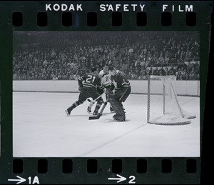 Toronto Maple Leafs' goalie defending goal against Boston Bruins player