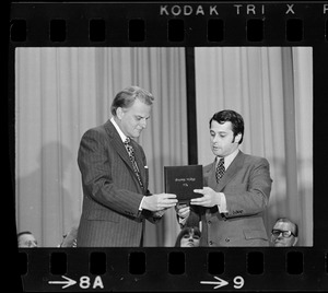 Billy Graham, left, on stage receiving an award from The Pilgrim Heritage