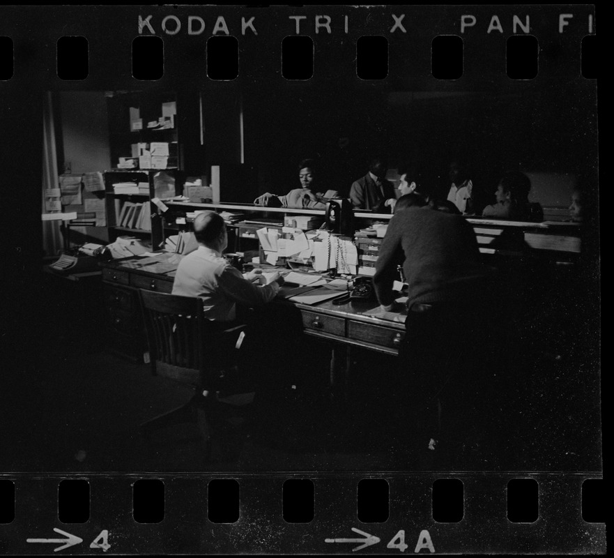 People working behind desk in office during Boston blackout