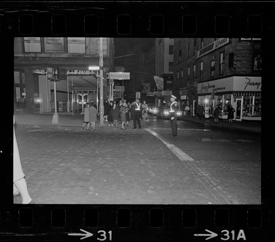 Police officer directing traffic and pedestrians at an intersection during Boston blackout