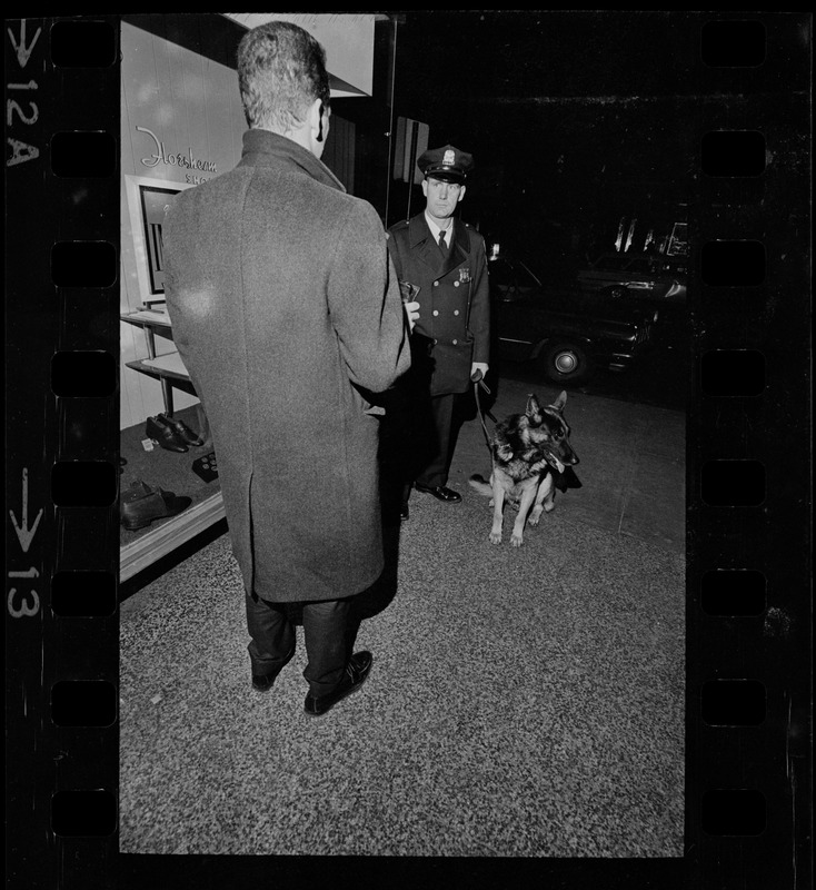 Man talking to police officer with dog during Boston blackout