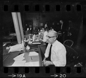 Man sitting at desk in a large office during Boston blackout