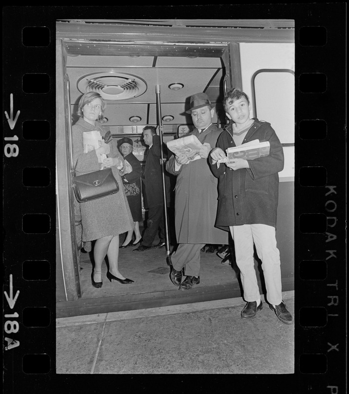 People standing in open train car doorway during Boston blackout