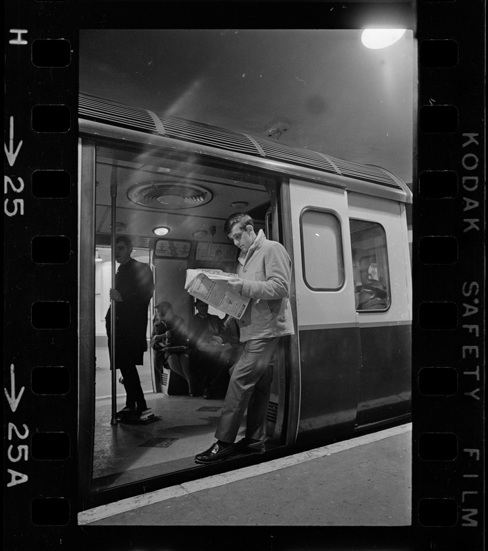 Man standing in lit train car doorway during Boston blackout