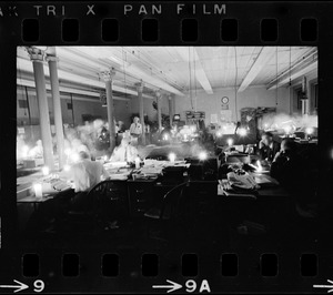 People in a large office lit by candlelight during Boston blackout