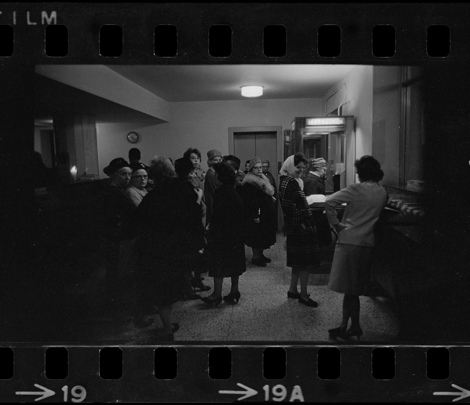 People waiting in line for telephone during Boston blackout