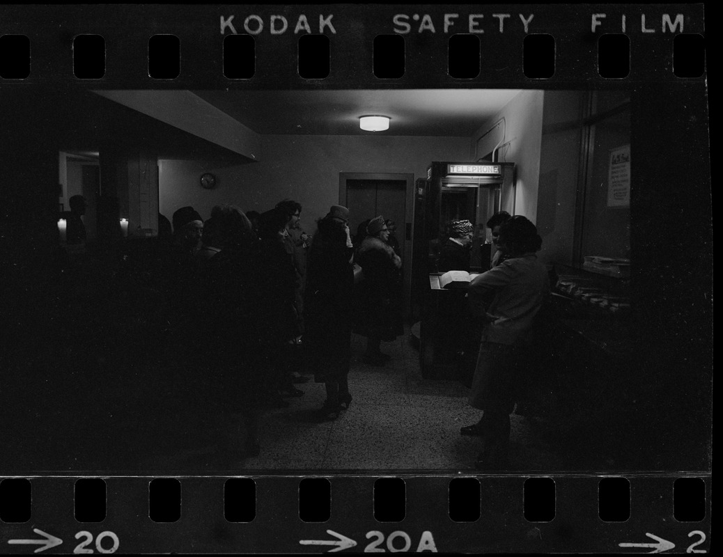 People waiting in line for telephone during Boston blackout