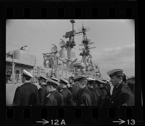 Transfer and commissioning of German missile destroyer ceremony, naval officers in foreground, ship seen in background