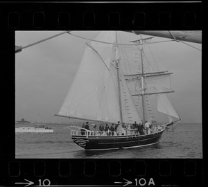 Framed through the rigging of the schooner, Spray, the sailing ship Black Pearl sails out of Boston Harbor, concluding the commemoration of the Hawaiian Mission Sesquicentennial