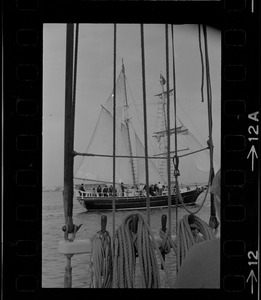 Framed through the rigging of the schooner, Spray, the sailing ship Black Pearl sails out of Boston Harbor, concluding the commemoration of the Hawaiian Mission Sesquicentennial