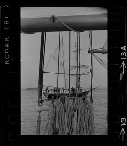 Framed through the rigging of the schooner, Spray, the sailing ship Black Pearl sails out of Boston Harbor, concluding the commemoration of the Hawaiian Mission Sesquicentennial