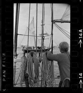 Framed through the rigging of the schooner, Spray, the sailing ship Black Pearl sails out of Boston Harbor, concluding the commemoration of the Hawaiian Mission Sesquicentennial