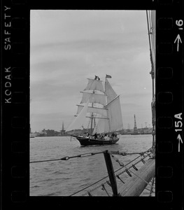 Framed through the rigging of the schooner, Spray, the sailing ship Black Pearl sails out of Boston Harbor, concluding the commemoration of the Hawaiian Mission Sesquicentennial