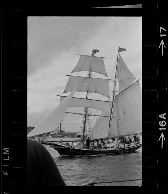 Framed through the rigging of the schooner, Spray, the sailing ship Black Pearl sails out of Boston Harbor, concluding the commemoration of the Hawaiian Mission Sesquicentennial