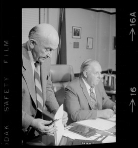 Two men seen at a desk in an office