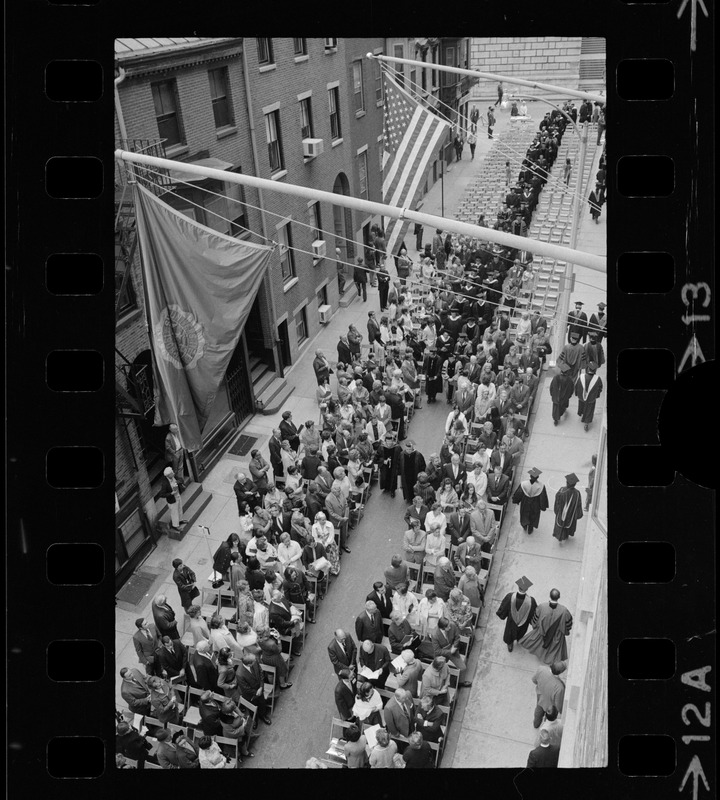 Narrow rows of seats at Suffolk University graduation with procession walking down aisle