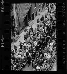 Narrow rows of seats at Suffolk University graduation with procession walking down aisle