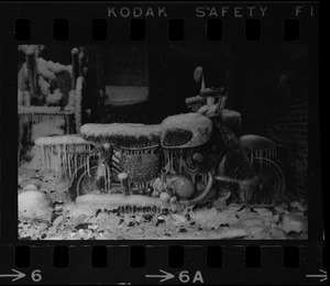 Motorbike covered in ice in the ruins of a fire in the North End