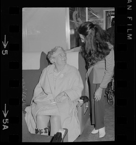 Phyllisa Farnor, conductorette, talks to a woman on train for first Amtrak run from Boston's South Station headed to New York