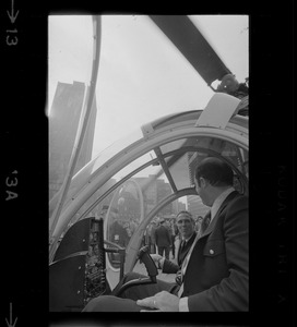 Mayor Kevin White speaks to helicopter pilot inside the cock pit