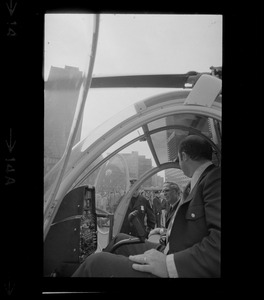 Mayor Kevin White speaks to helicopter pilot inside the cock pit