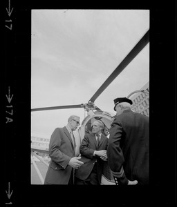 Boston Mayor Kevin White, Police Lieutenant John Dow and one other man discussing the helicopter for police work at City Hall Plaza